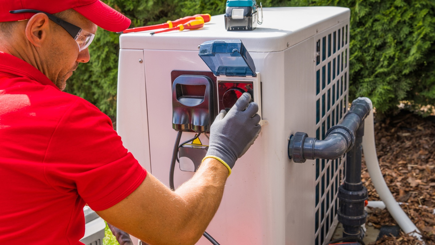 Technician inspecting a pool heating or circulation unit